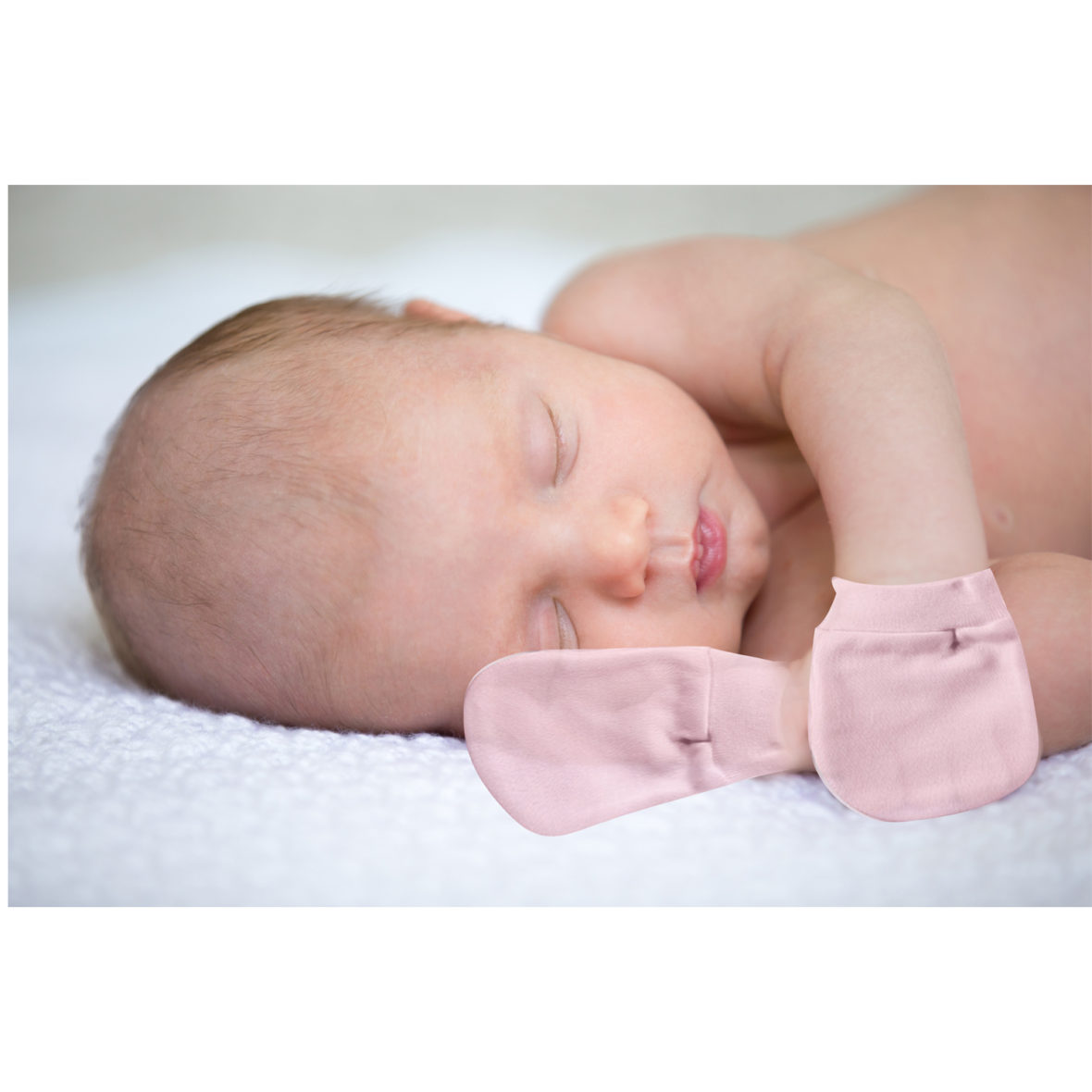 New born child sleeping on white blanket